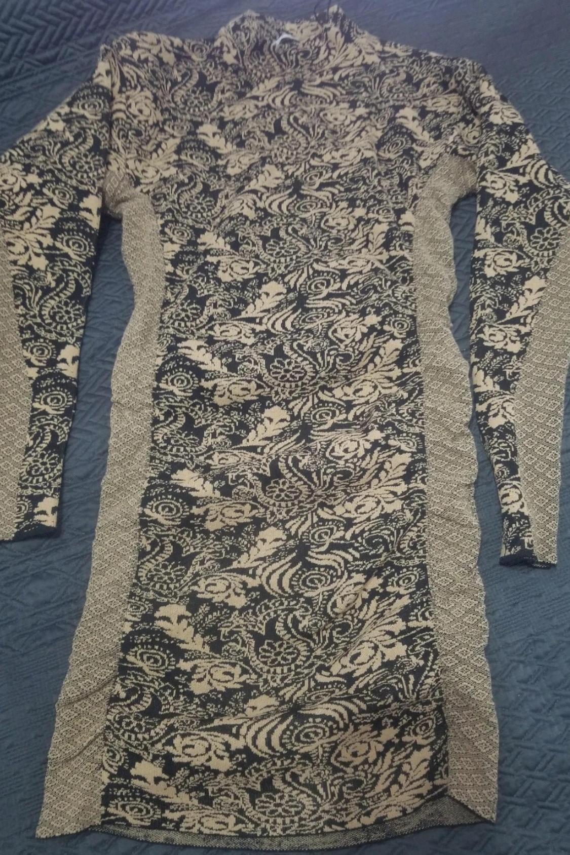 Front view of a floral print dress in beige and black tones with long sleeves.