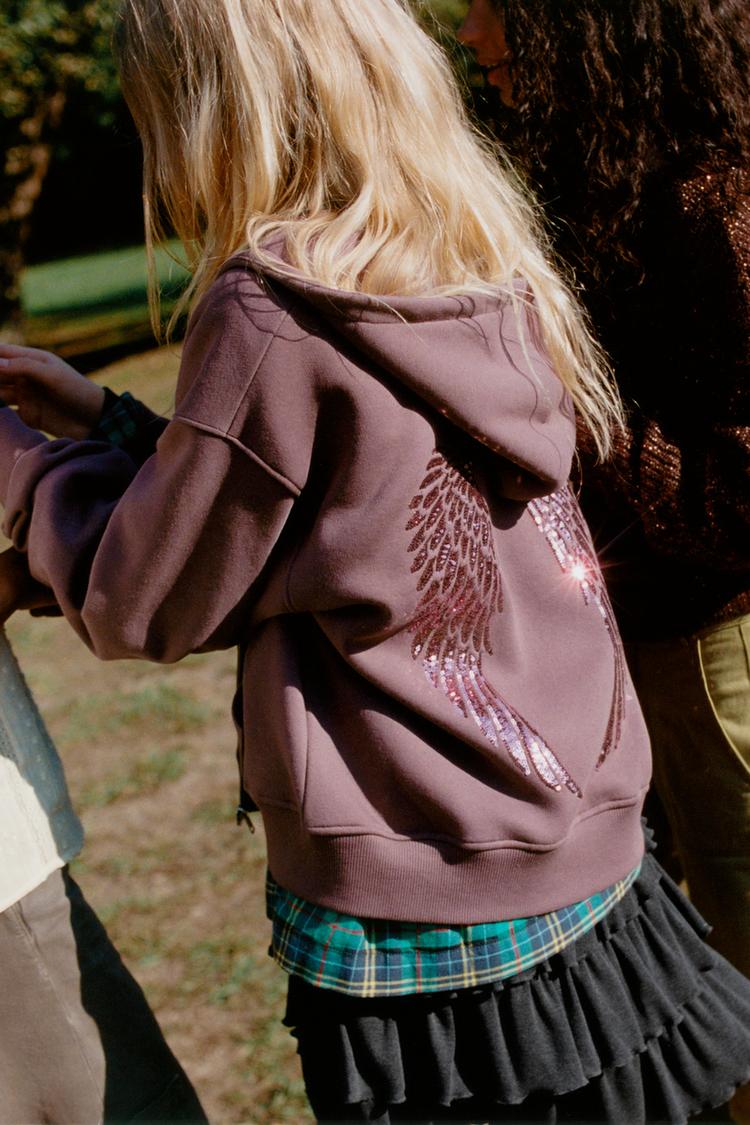 Sudadera cremallera alas lentejuelas