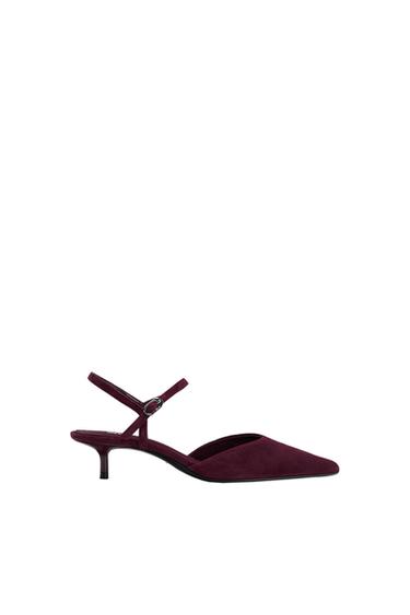 Burgundy low-heeled shoe with a pointed toe and adjustable strap, on a white background.