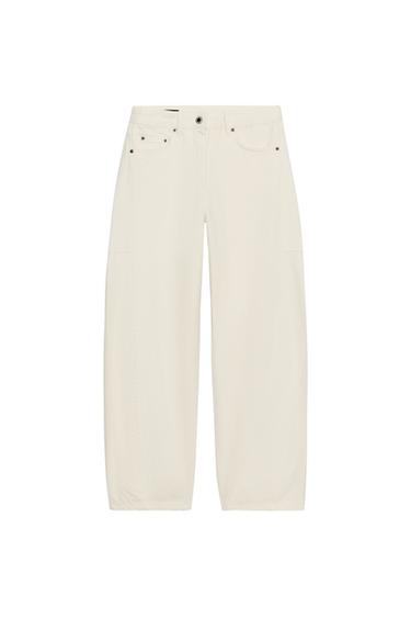 Front view of white wide-leg trousers with front and back pockets, button and zip fastening.
