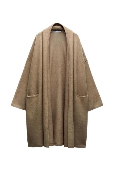 Long, loose-fitting open-knit cardigan in beige with front pockets. ZARA label on the neck.