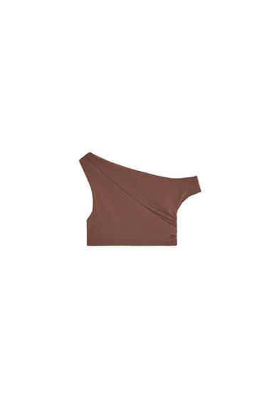 Side view of asymmetric brown top with a single strap.