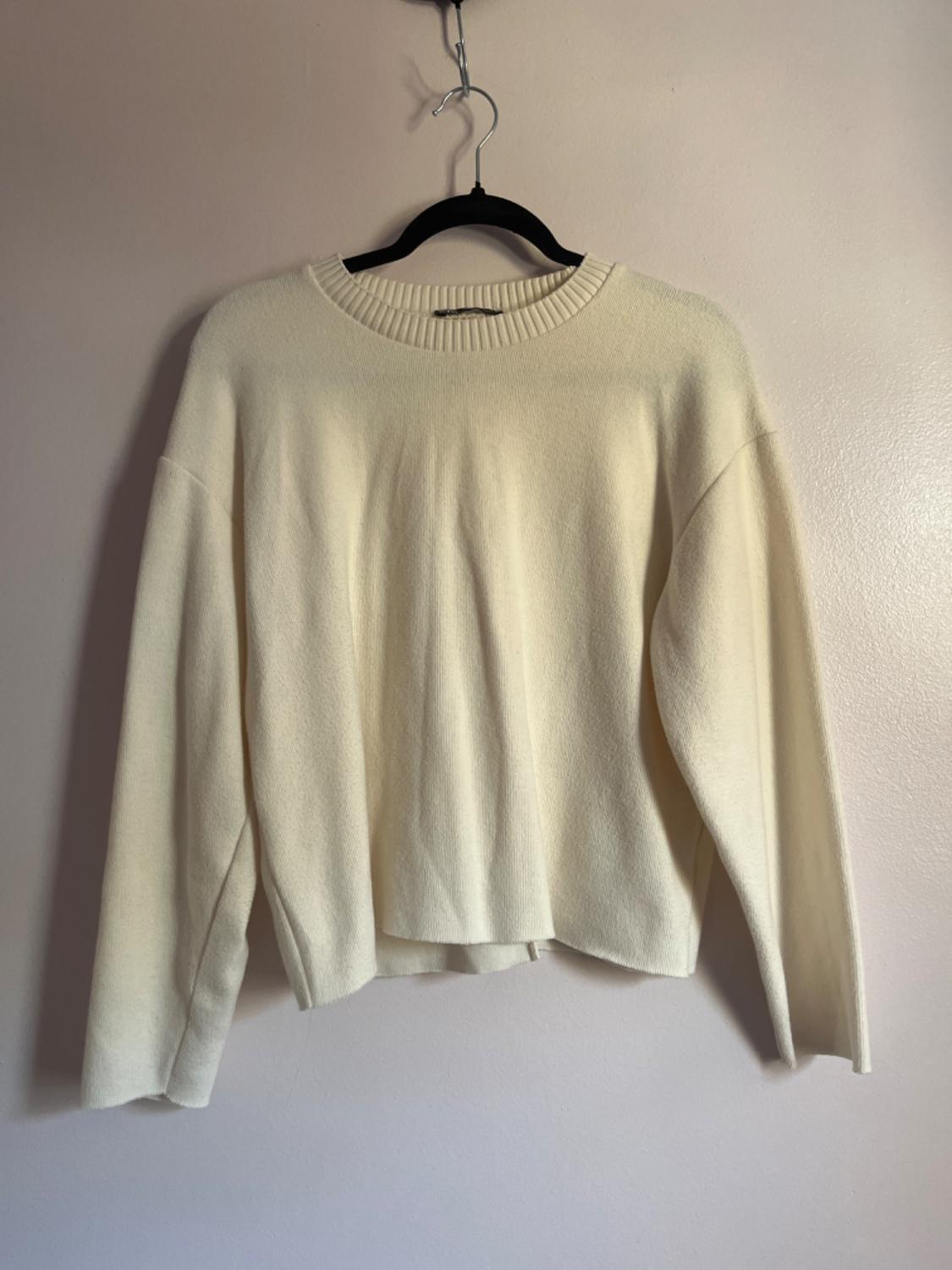 Front view of a beige, long-sleeved, crew-neck sweater.