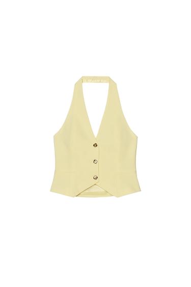 Front view of a light yellow waistcoat with a three-button fastening and side pockets.