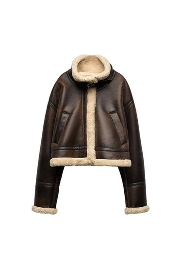Front view of a brown jacket with a high collar and sheepskin lining, side pockets, and front closure.