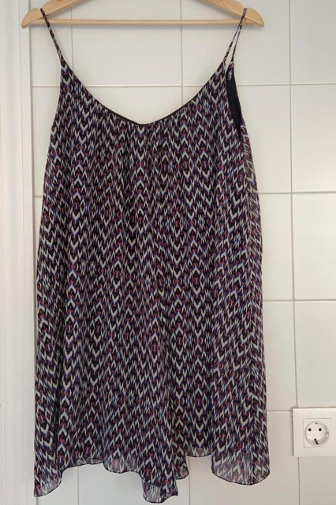 Front view of geometric print dress with thin straps.