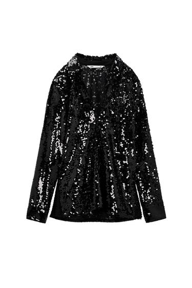 Blouse with V-neck lapel collar with long cuffed sleeves. Side vents at hem.