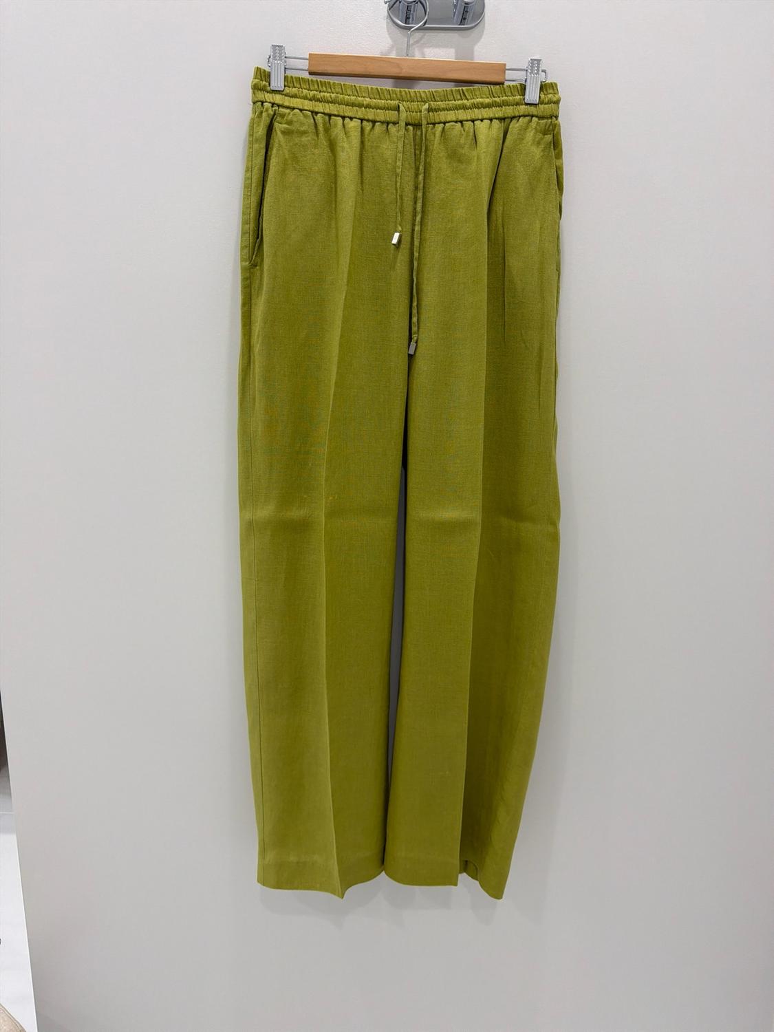 Wide-leg green pants with an elastic waistband and adjustable drawstring, hanging on a wooden hanger against a white background.