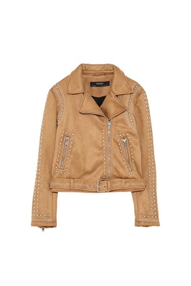 Front view of a beige jacket with silver studs, zip fastening and front zip pockets.