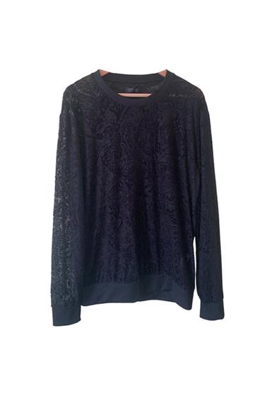 Front view of a black sweater with lace detailing and a round neck.