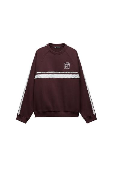 Front view of a brown sweatshirt with white trim and the text 'NY' on the chest.