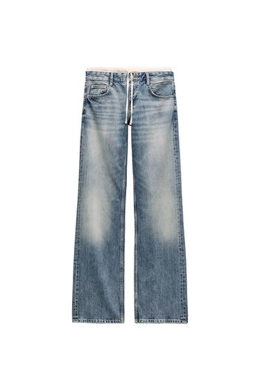 Front view of light blue wide-leg jeans with front pockets and adjustable waistband.