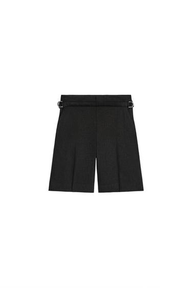 Rear view of a pair of black pleated shorts with belt.