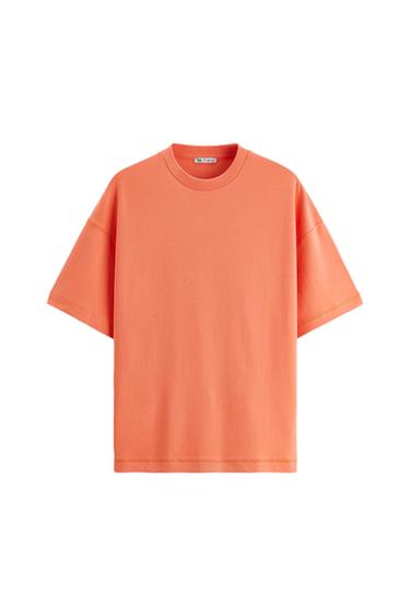 Orange short-sleeved T-shirt with a round neck. Visible label inside the collar. White background.