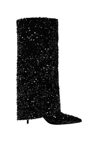 Black high boot with shiny sequins on a white background. Elegant and modern design, ideal for standing out at night events.