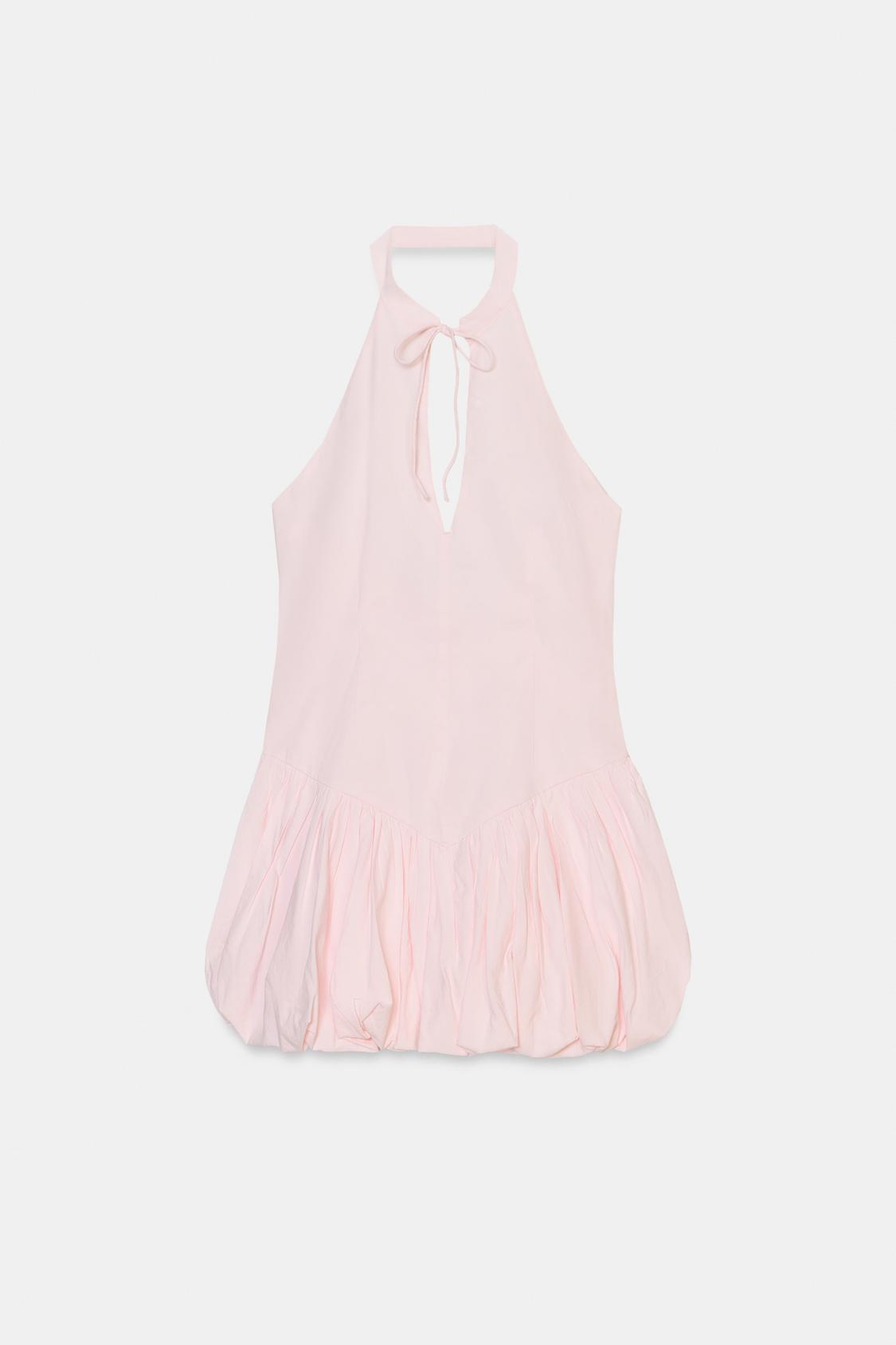 Front view of a light pink short dress with a halter neck and tie, a V-neckline, and a pleated balloon hem.