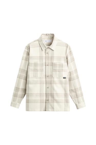 Front view of a beige plaid shirt with front pockets and button closure.