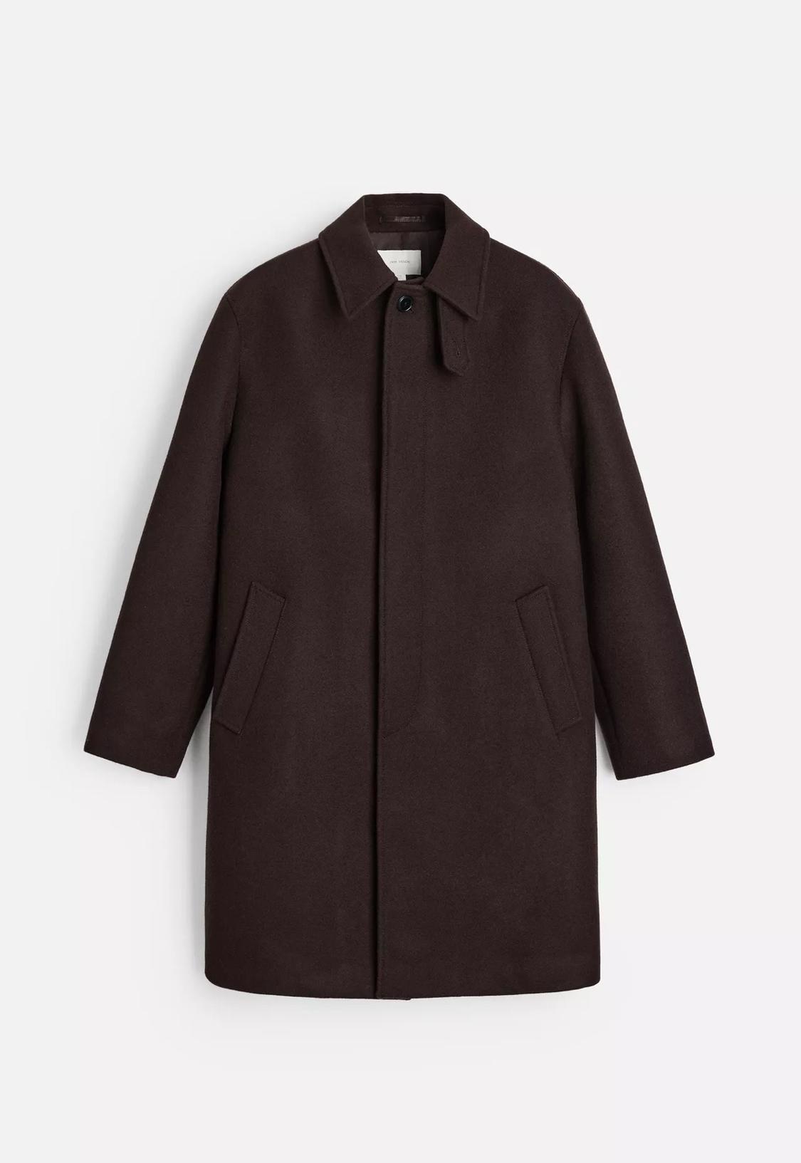 Dark brown long coat with a classic collar, concealed front fastening and side pockets against a white background.