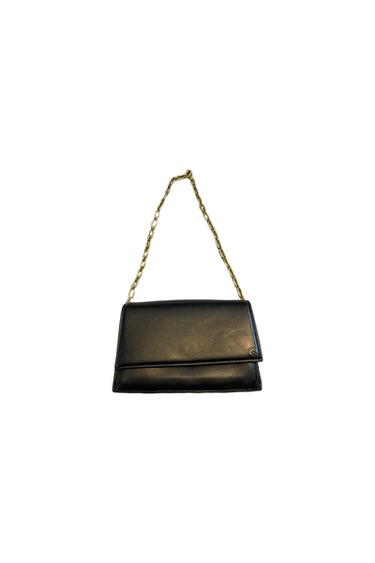 Black handbag with gold chain on a white background. Elegant and minimalist design.