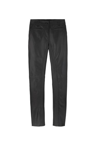 Black leather trousers with front pockets and belt loops, front view on a white background.