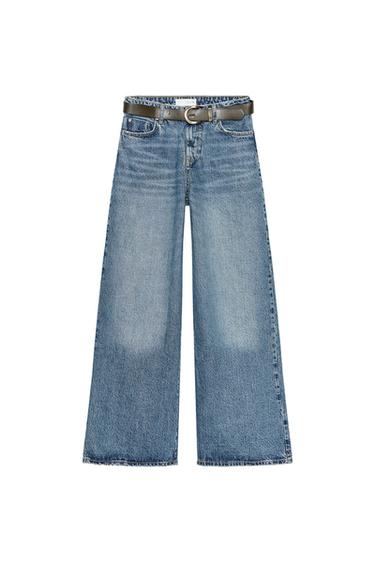 Front view of high-waisted, wide-leg, five-pocket, washed blue jeans. Front zip and button fastening.