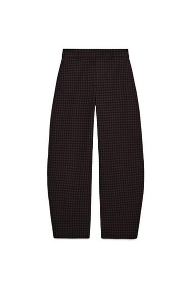 Front view of brown plaid pants with a mid-rise, side pockets, and buttoned hems. Front zip closure.