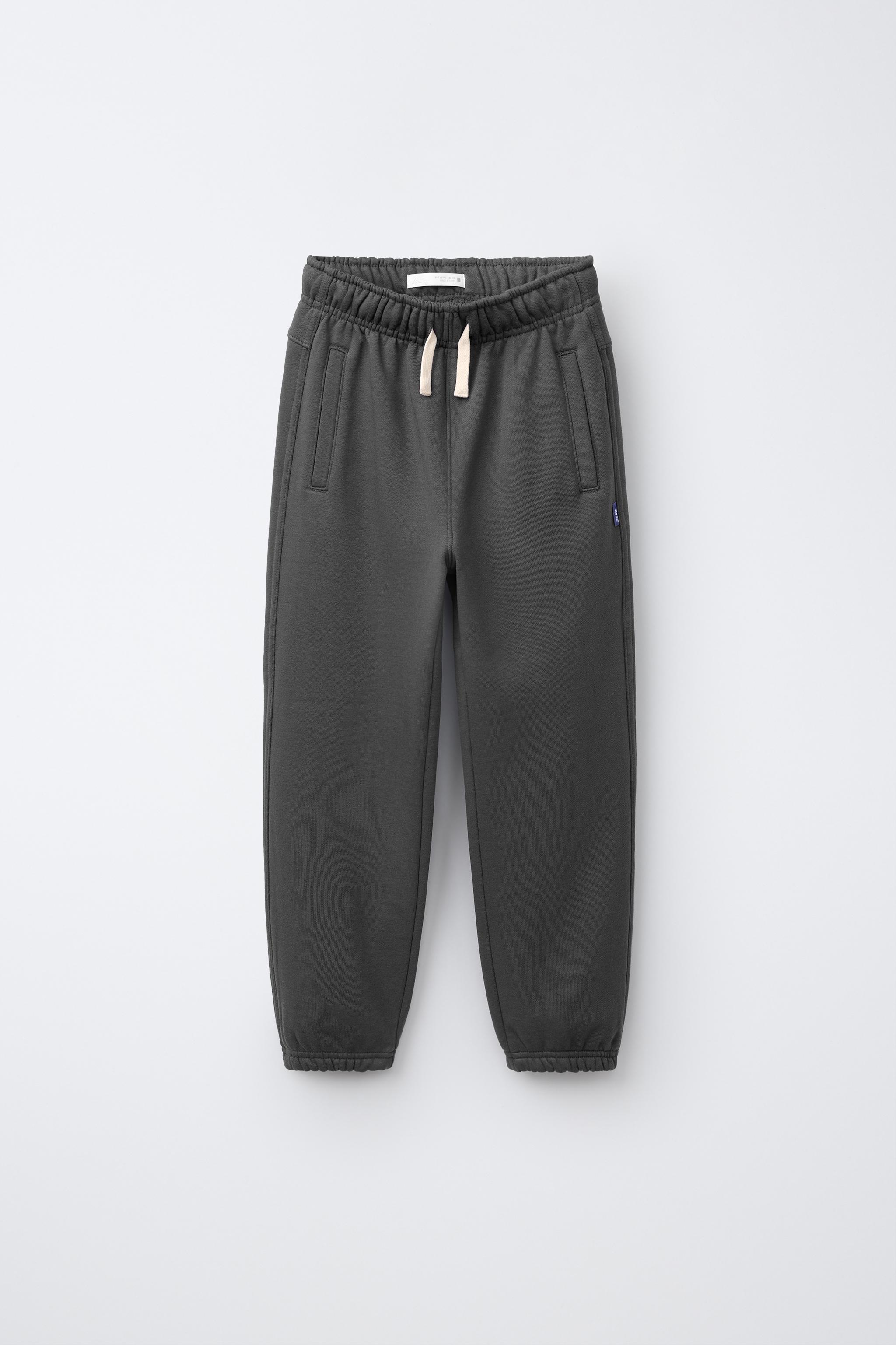 PANTALON DE JOGGING EN MOLLETON UNI AVEC ÉTIQUETTE