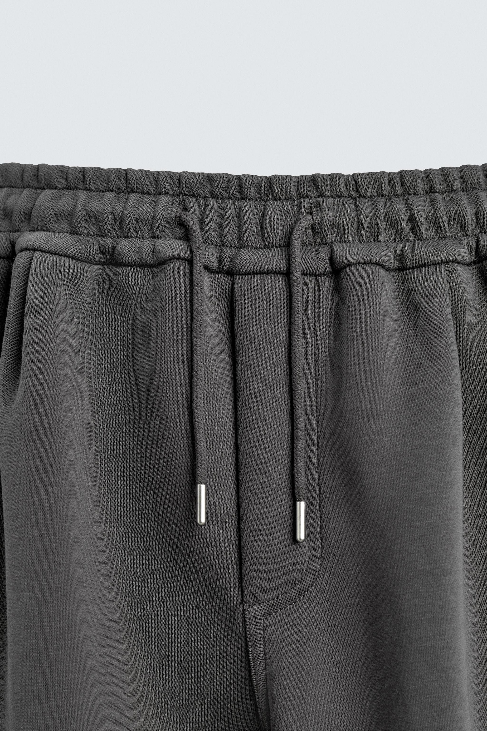 NEOPRENE EFFECT CARGO PANTS WITH PLEATS
