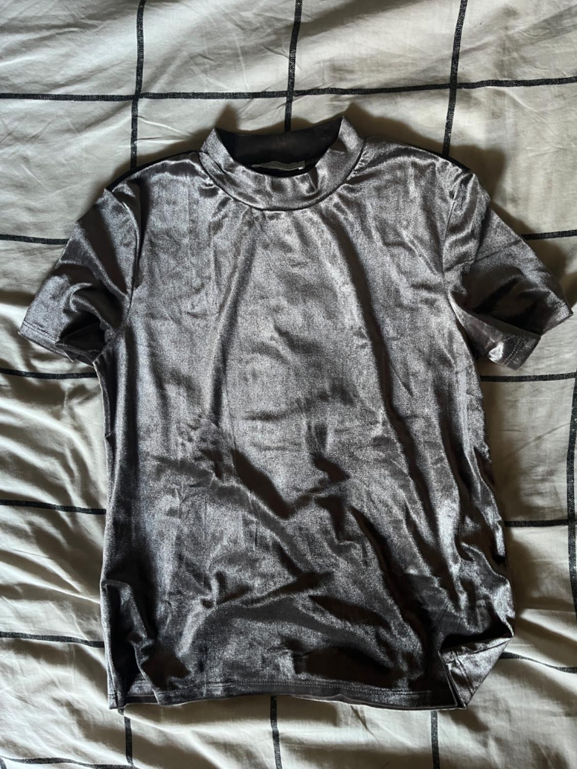 Front view of a gray short-sleeved turtleneck t-shirt.