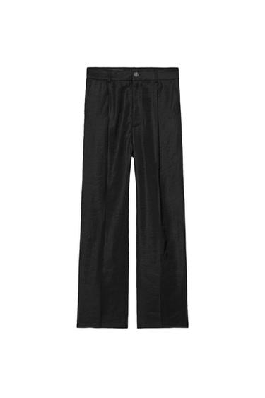 Front view of black trousers with button and front pleats.