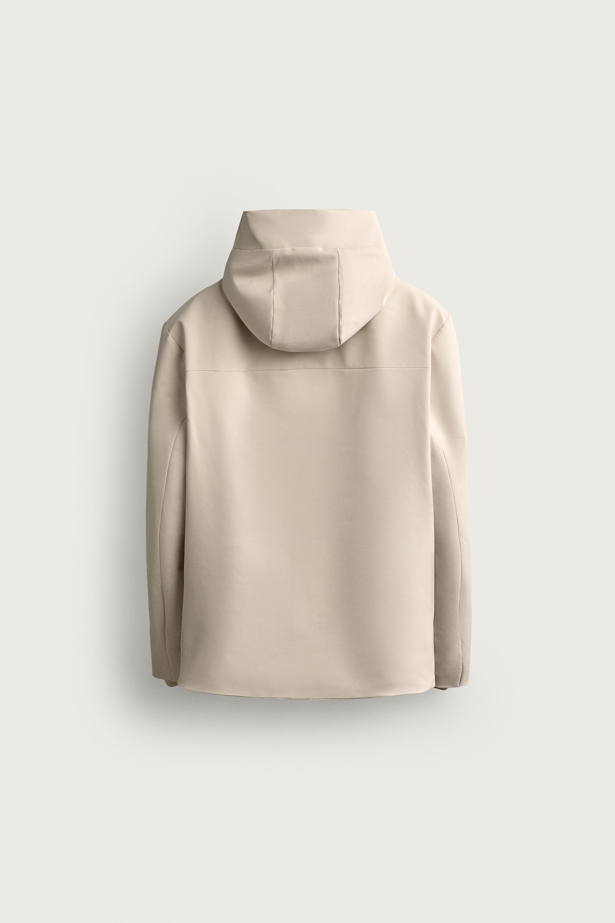 BLOUSON TECHNIQUE À CAPUCHE DÉPERLANT