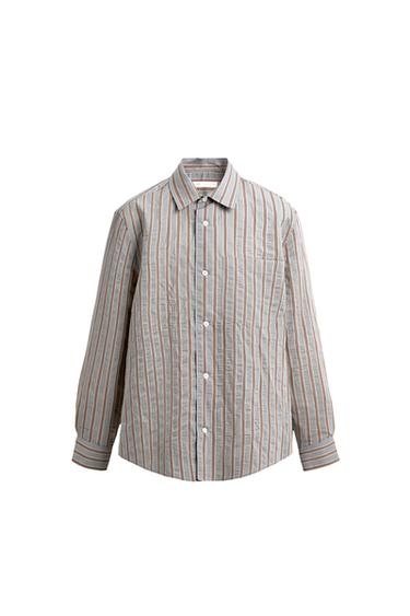 Front view of a light blue striped shirt, lapel collar, long sleeves with cuffs, front button fastening and patch pocket on the chest.
