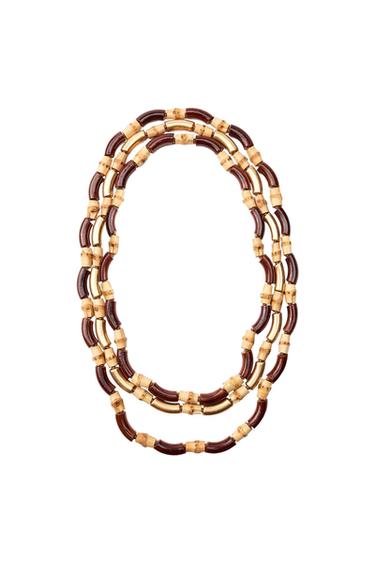 Multi-strand necklace with alternating dark brown and light beige bamboo-style tubular beads, on a white background.