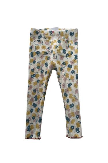 Front view of trousers with a floral print in yellow and pink tones, visible back pockets.