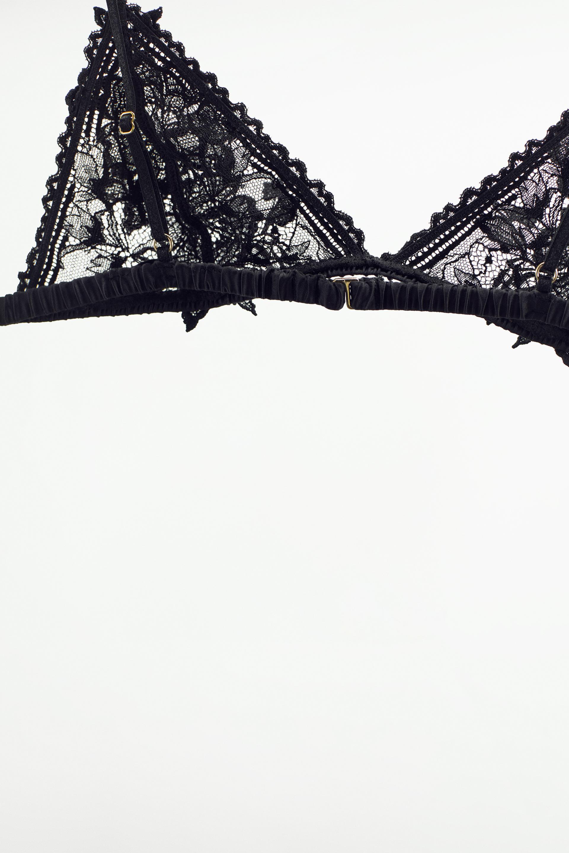 Triangle bralette with lace fabric. Lace trim. Adjustable thin straps. Back  hook closure.