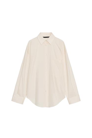 Front view of a light beige oversized shirt with a shirt collar, long sleeves, patch pocket and button-up front fastening.