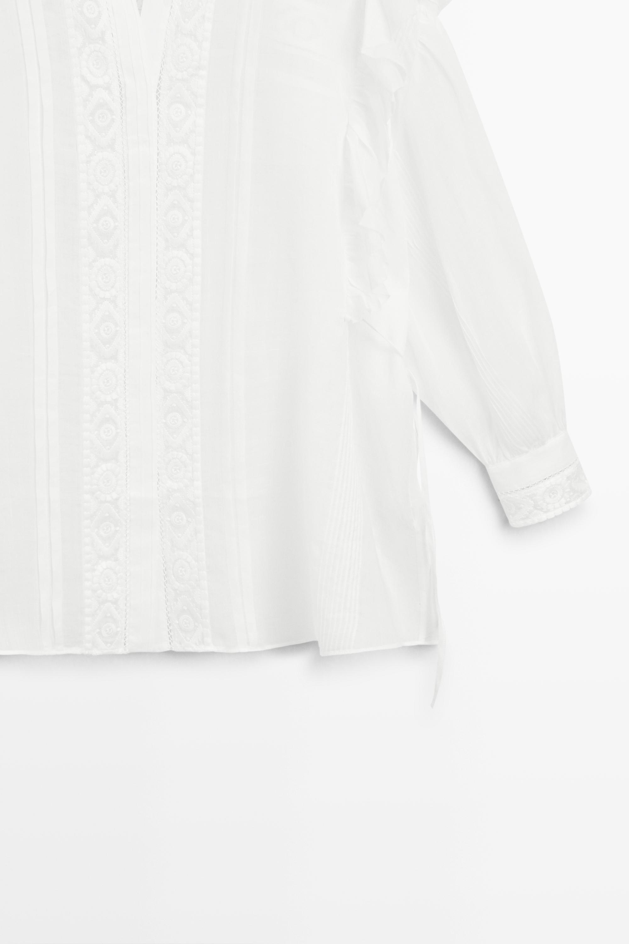 Stand collar blouse with embroidery and ruffles