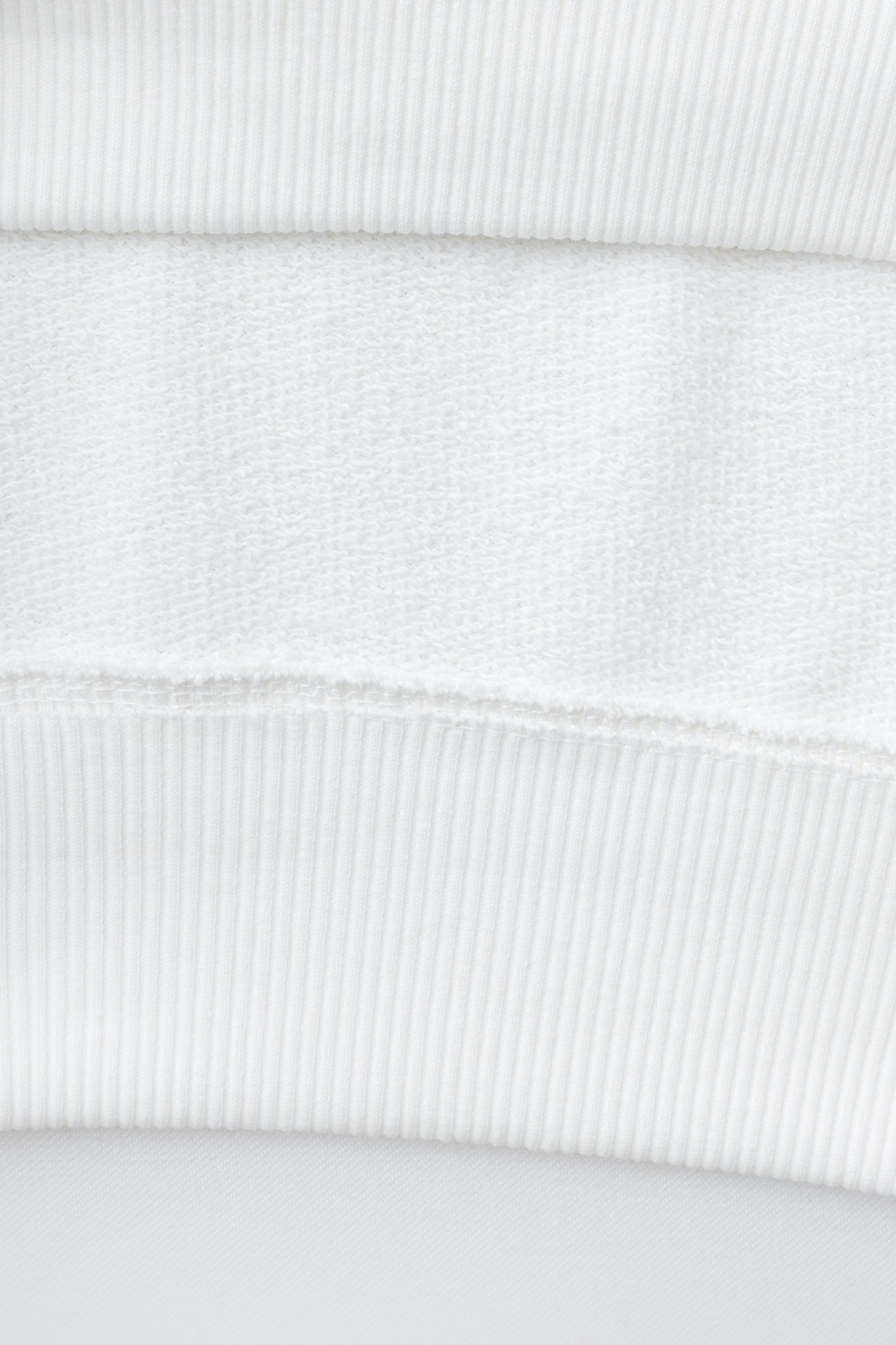 SWEAT AVEC PIÈCES ET INSCRIPTION