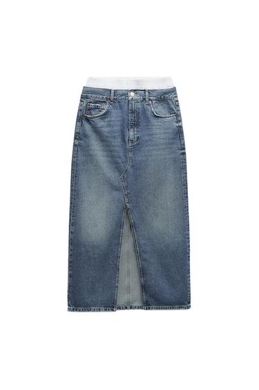 Blue denim midi skirt with a front split and a white elasticated waist. Classic design with front and back pockets.