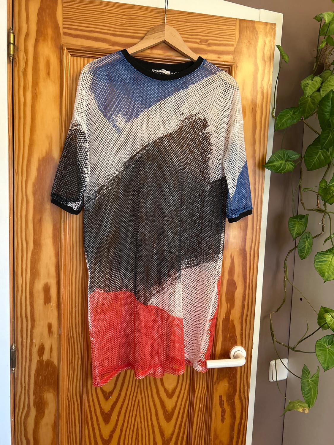 Front view of a mesh t-shirt with an abstract print in blue, black, white, and red.