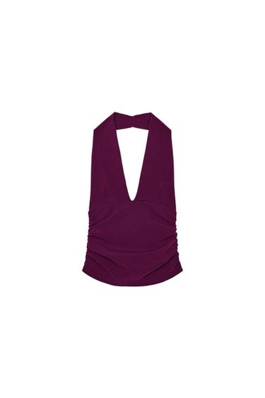 Front view of a purple top with a plunging neckline and waist pleats.