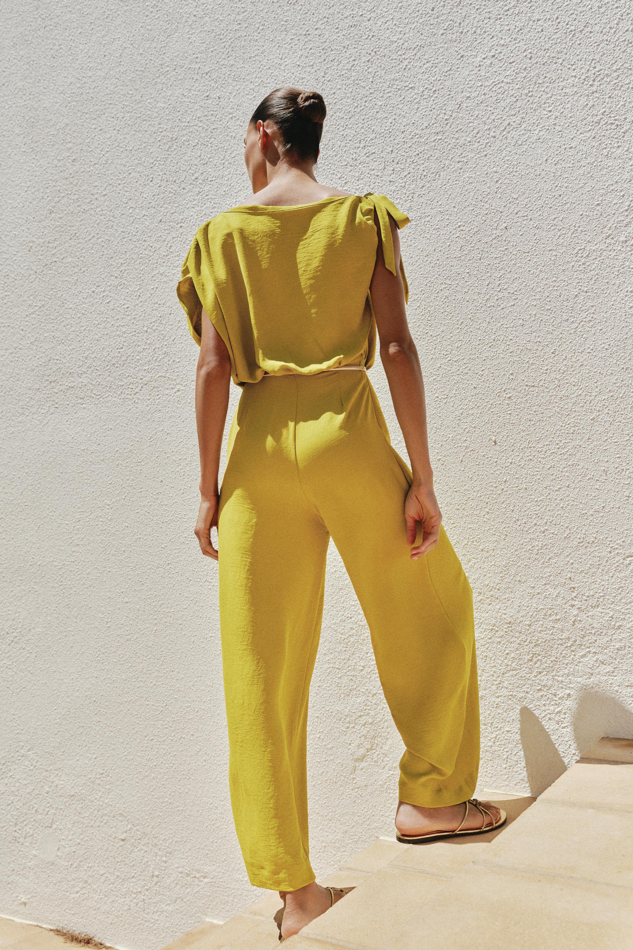 ASYMMETRIC SLEEVE BELTED JUMPSUIT