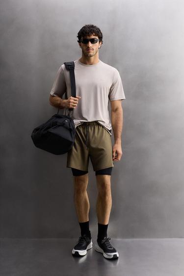 SHORTS STËRVITJEJE 2 NË 1 - Kaki e errët nga Zara