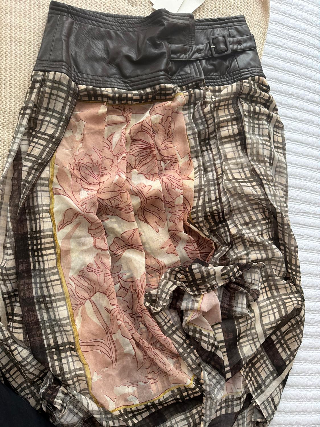 Skirt with black leather waistband, brown plaid print, and a central floral panel in pink and beige on a light background.