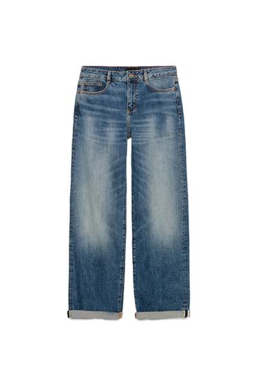 Front view of high-waisted, relaxed-fit blue jeans, with five pockets and turn-up hems. Front zip and button fastening.