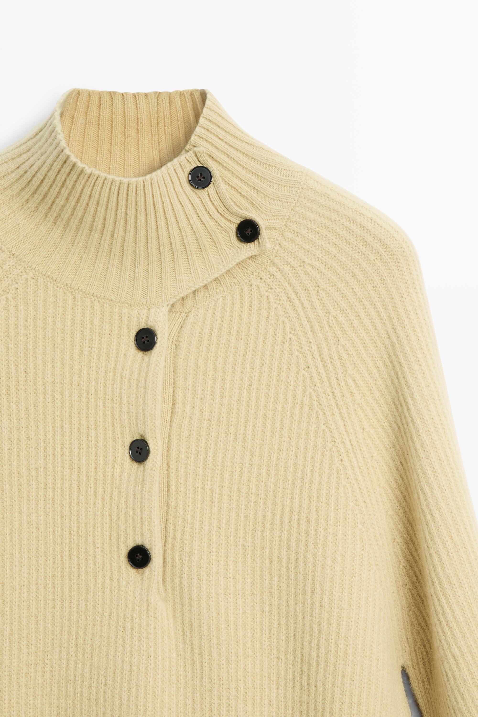100% wool knit cape with button detail