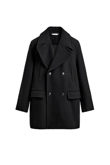 Front view of a black double-breasted pea coat with wide lapels, jetted pockets on the chest, and flap pockets on the hip.