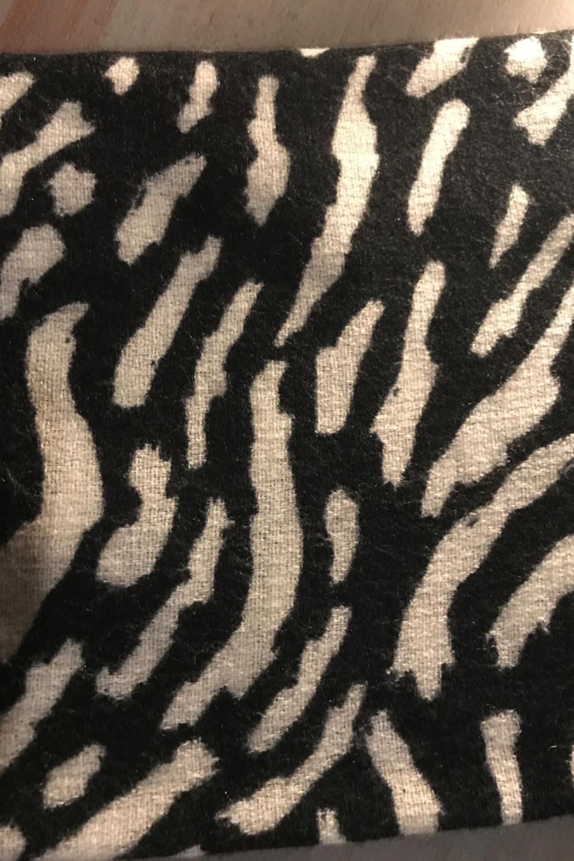 Black and white print detail with an abstract pattern.