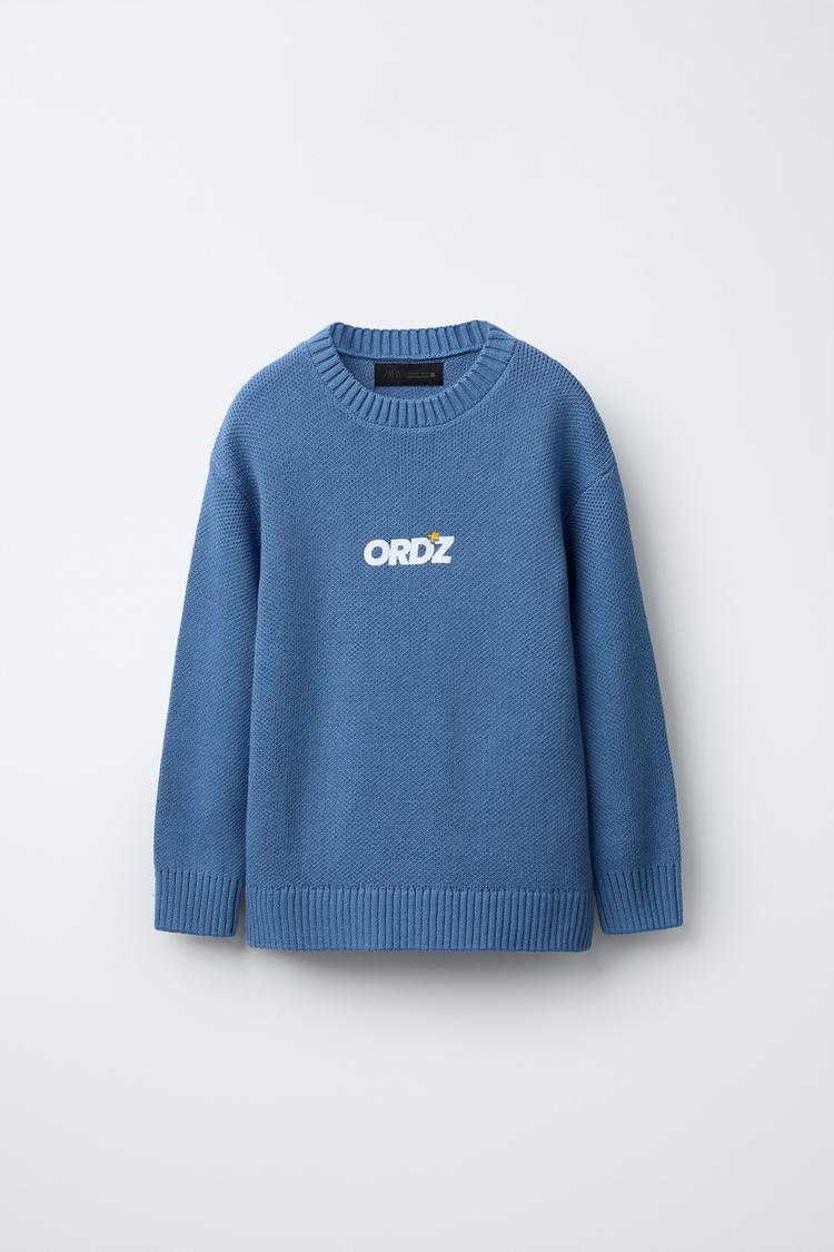 KNIT SWEATER WITH SLOGAN