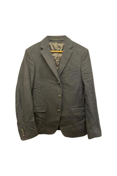 Front view of a grey jacket with lapels, two buttons, and side flap pockets.